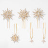 Set of gold and pearl hairpins on a white background
