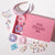 60 Pieces Unicorn DIY Gift Box with 18 Hair Accessories, 24 Charms, 1 Bag Charm, Holographic Pouch & more - Pink & Purple
