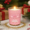 Pink candle labeled 'Marshmallow Whip' with Christmas decorations in the background