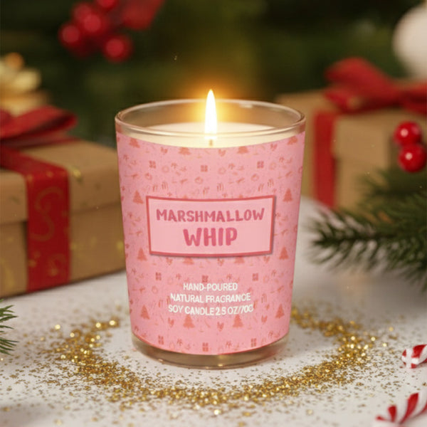 Pink candle labeled 'Marshmallow Whip' with Christmas decorations in the background