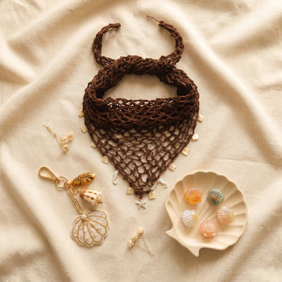 Summer hair accessories gift collection with crochet scarf, shell claw clips, and coastal bag charm