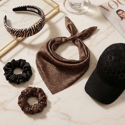 Jungle Chic Box with leopard print scarf, scrunchies, headband, and crochet cap for getaways.