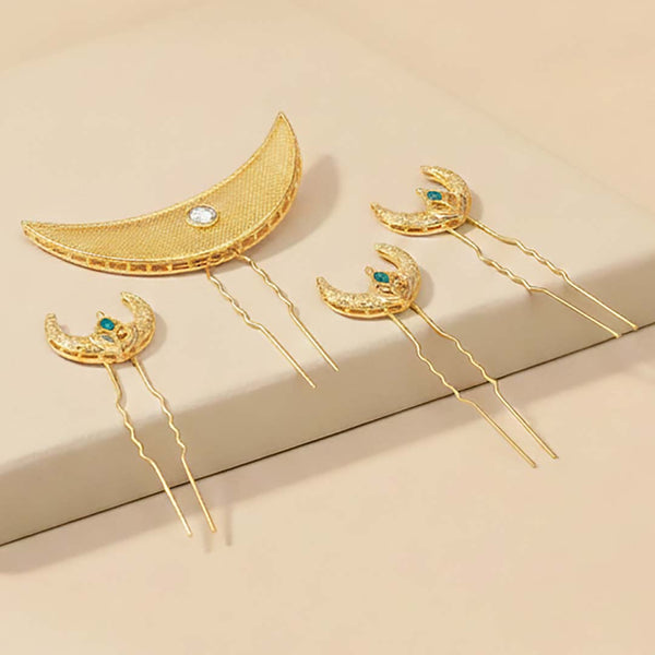 Set of gold hairpins with moon designs on a beige background