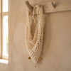 Off white headscarf in crochet thread with gold charm accents, wears as hair wrap or bandana